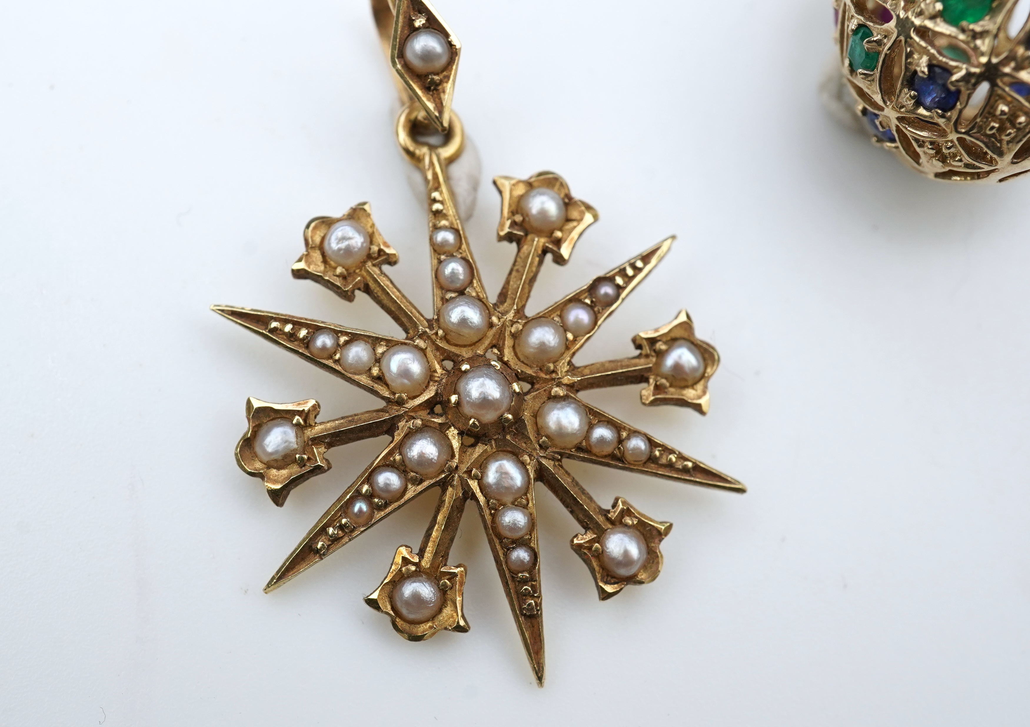 A gem-set egg pendant and an Edwardian seed pearl pendant